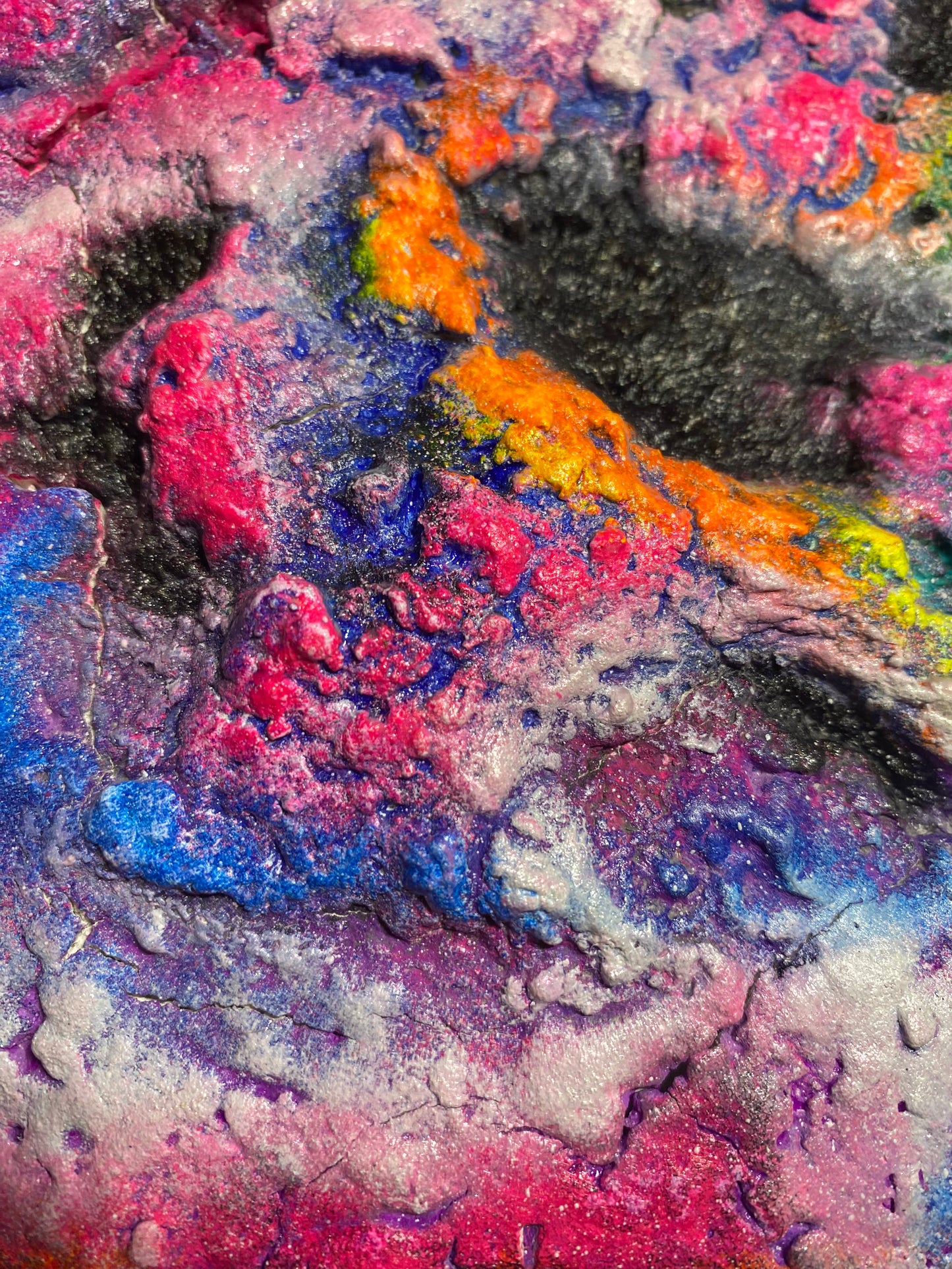 Melting Galaxy neon painting by Melted Glam – vibrant textured 3D artwork in neon pink, orange, green, and blue with cosmic galaxy patterns. close up